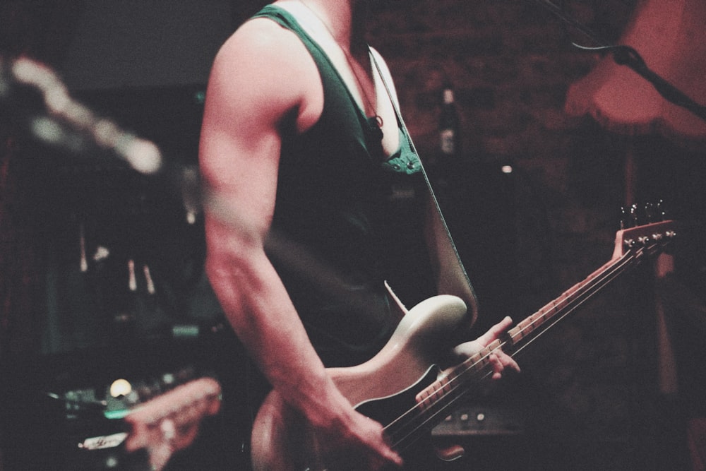 man holding electric guitar