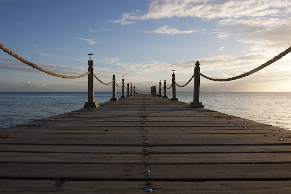 landscape photo of sea dock under stratocumulus clouds