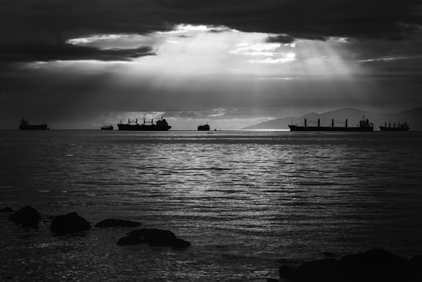grayscale photo of ships on water