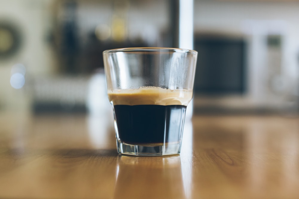 clear shot glass on wooden table