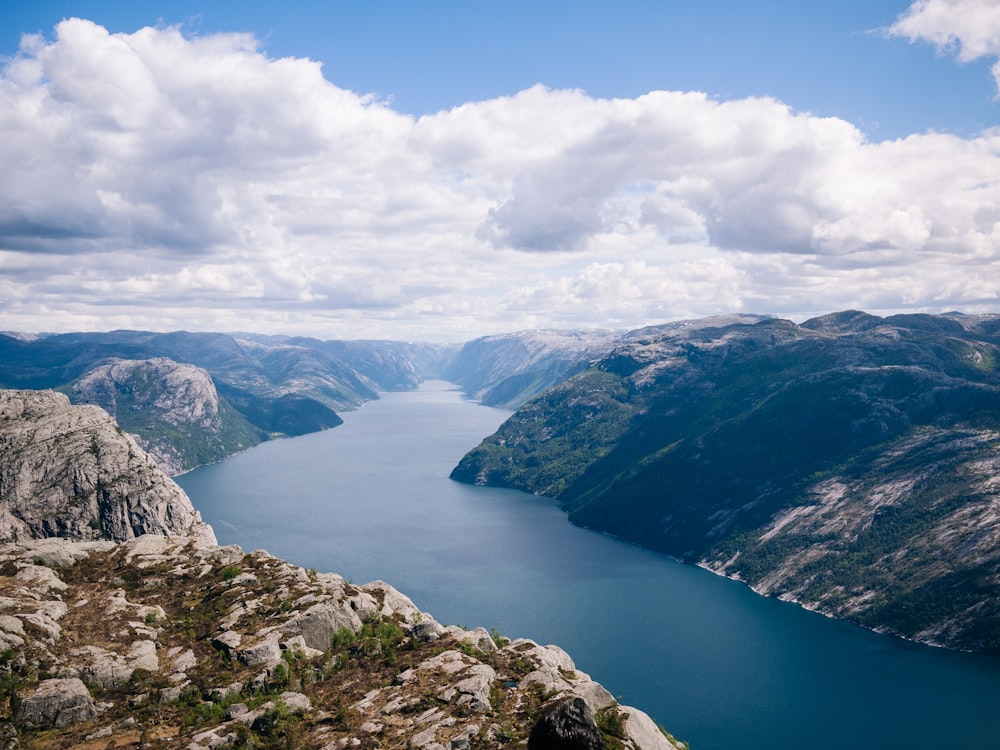 landscape photo of body of water between mountains