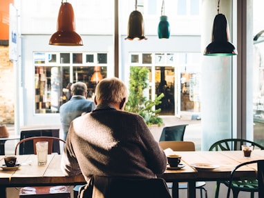 man in chair with table beside coffee