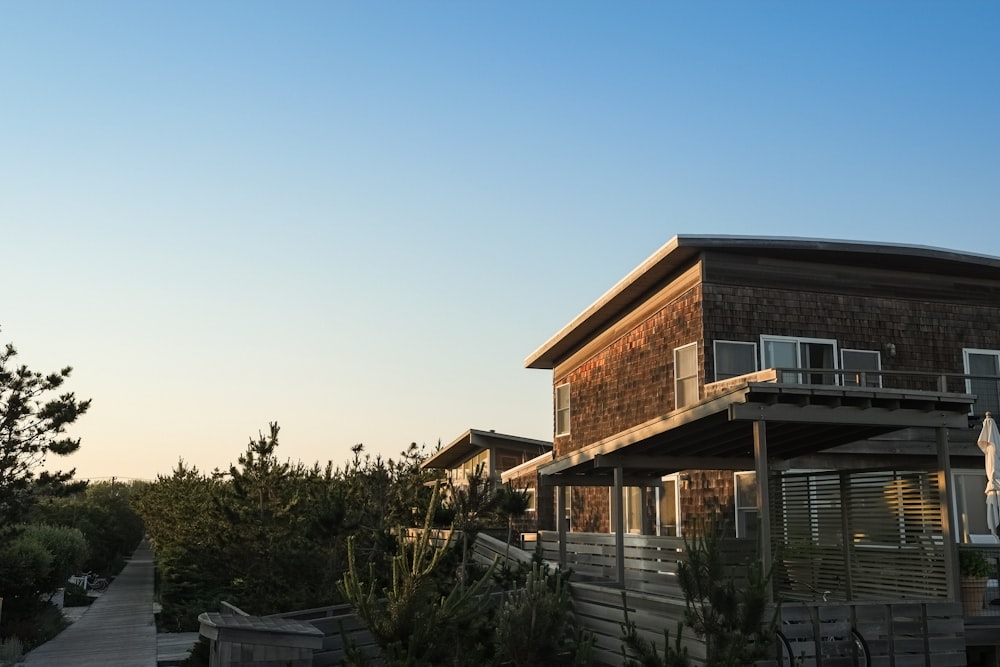 brown painted house with brown wooden fence