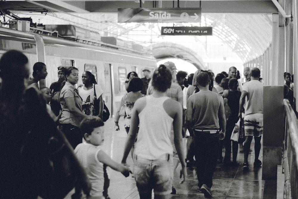 grayscaled photo of crowd on subway