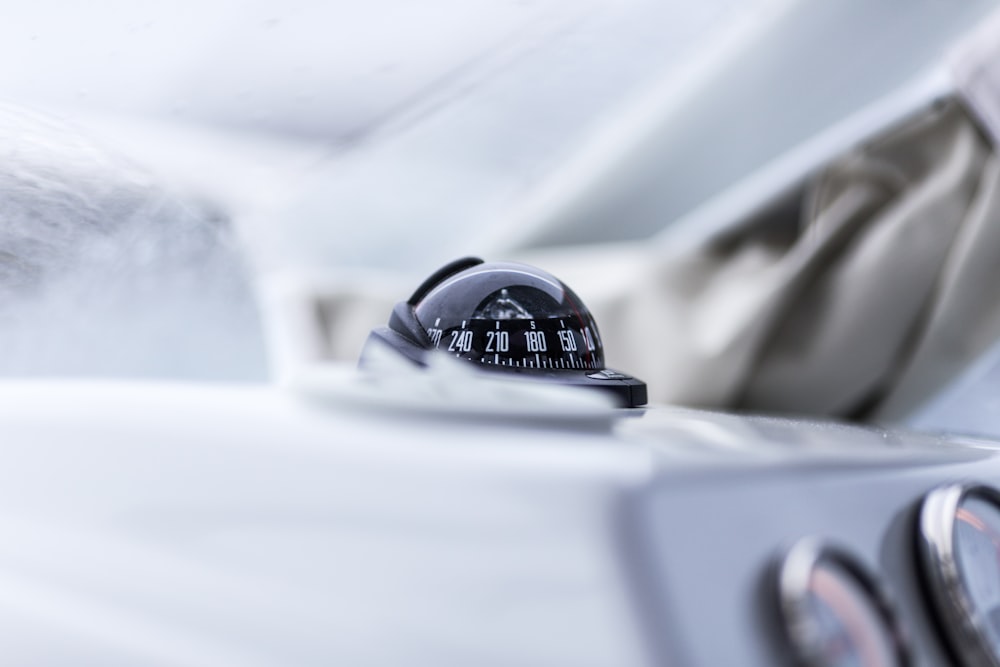 closeup photography of vehicle compass