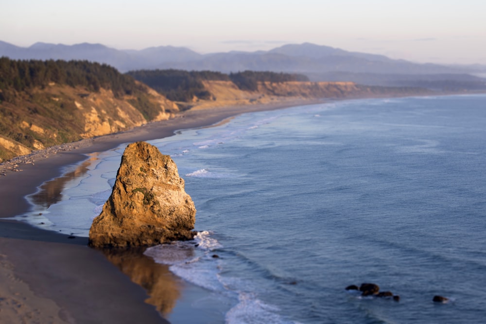 rock formation on seashore during daytime