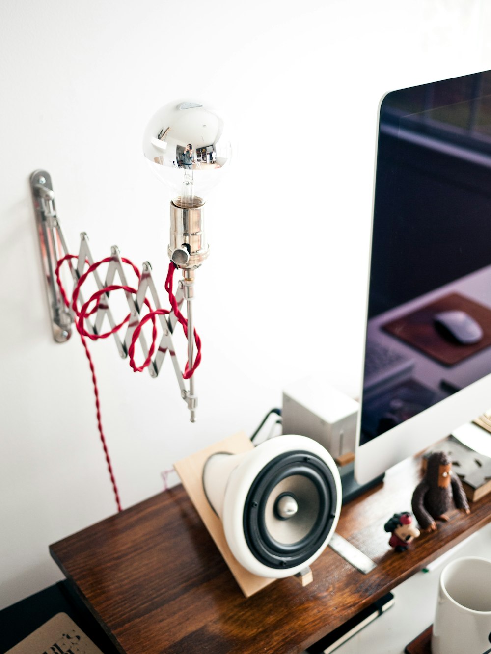 white and black speaker on brown wooden table