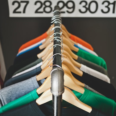 assorted-color hanged shirts with hangers