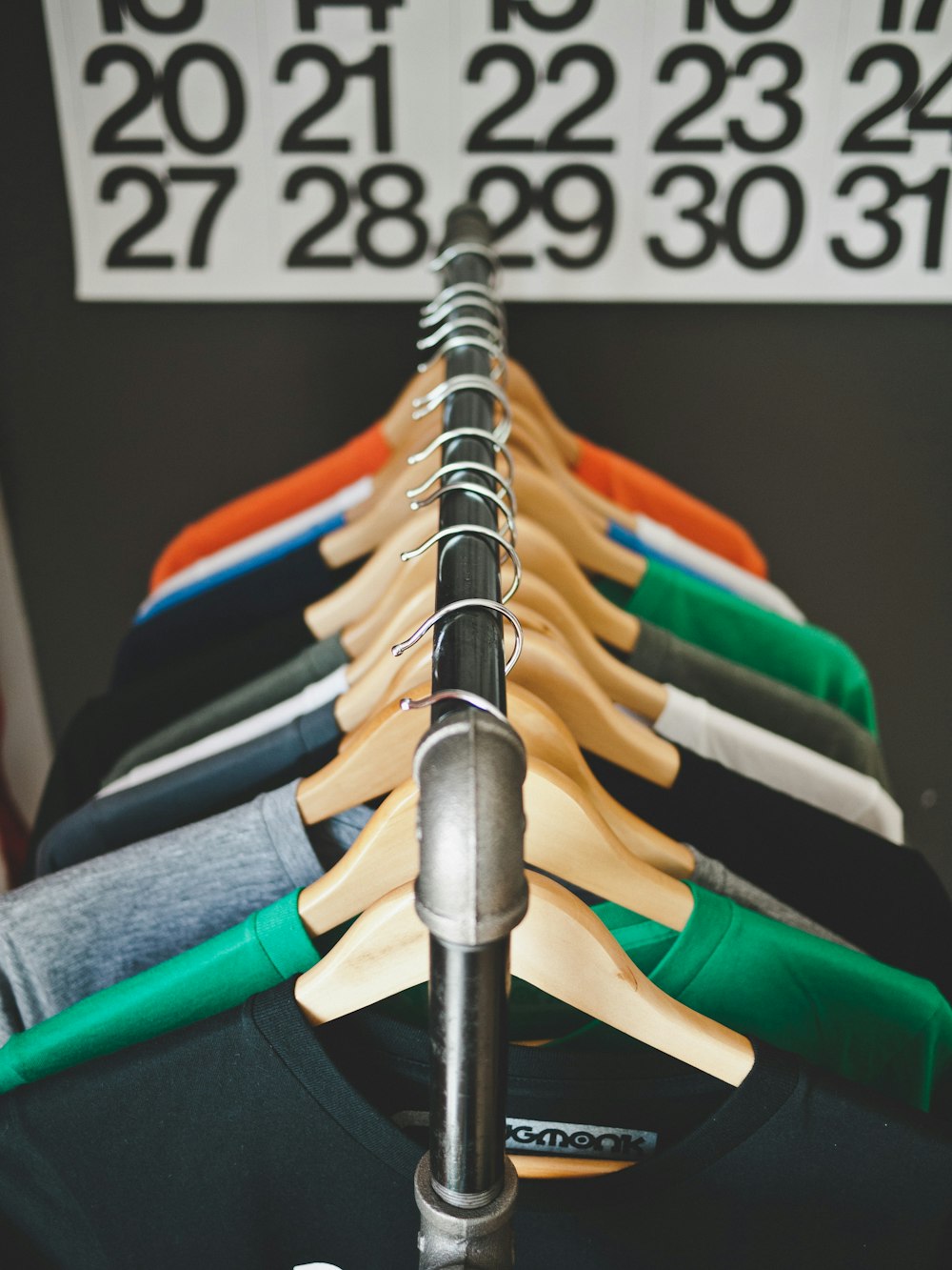 assorted-color hanged shirts with hangers