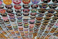 Rows of colorful fanhats lined up, ready for steaming and final touches.
