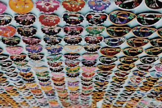 A colorful display of botanical-themed hats and clothing.