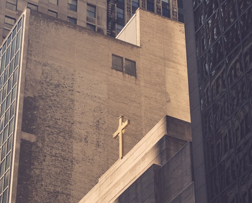 low angle photography of concrete building with cross