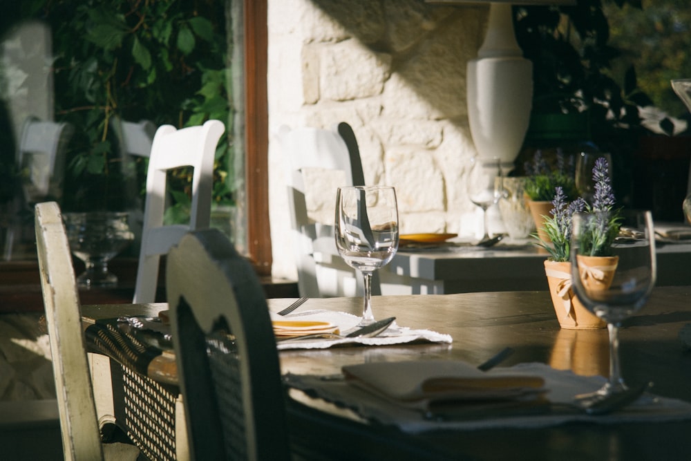 rectangular brown wooden table with wine glass