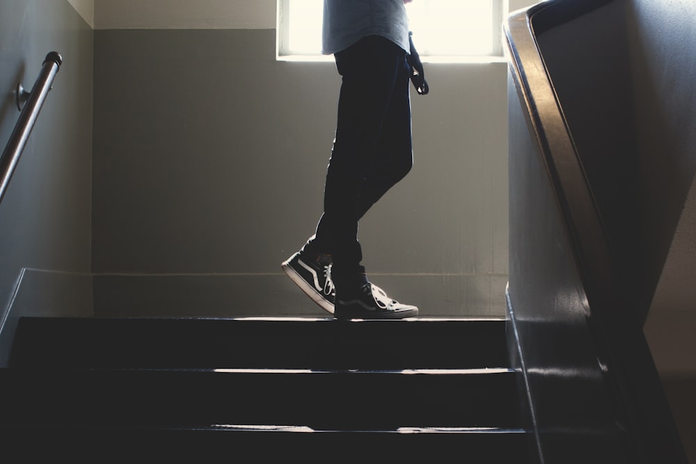 person standing on in a dim-lit stair