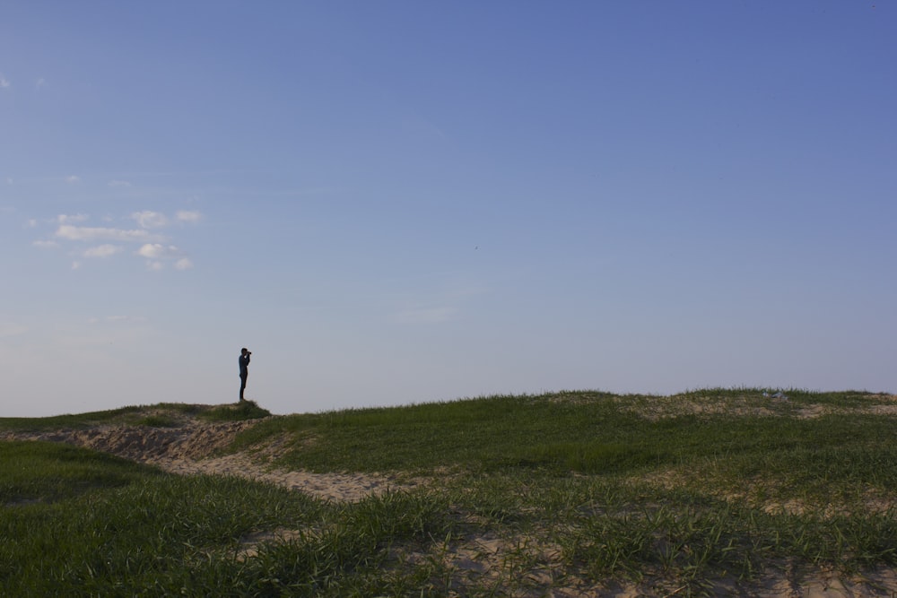 person standing on grass field