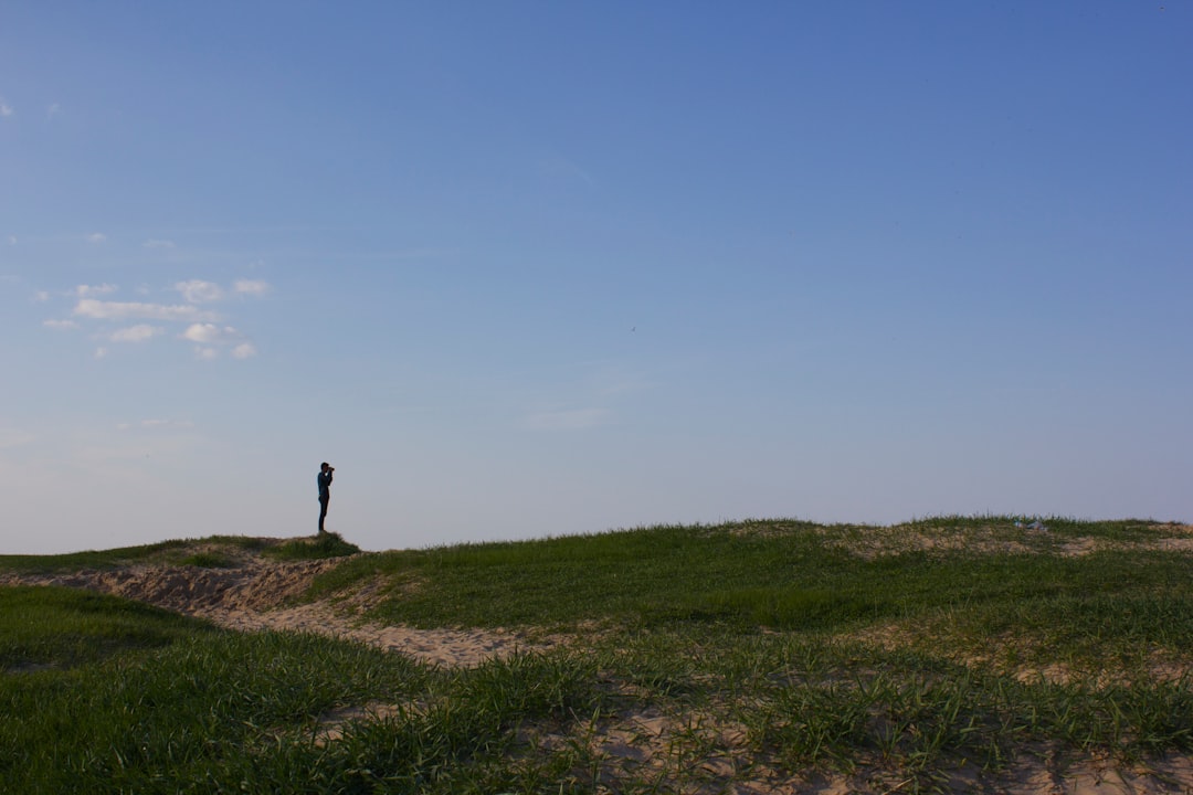 person standing on grass field