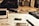 A workspace with technical drawings, a pen, a calculator, and a USB drive scattered on a desk. The setting suggests an environment focused on design or engineering, with blueprints and sketches partially visible. The lighting is warm and subdued.