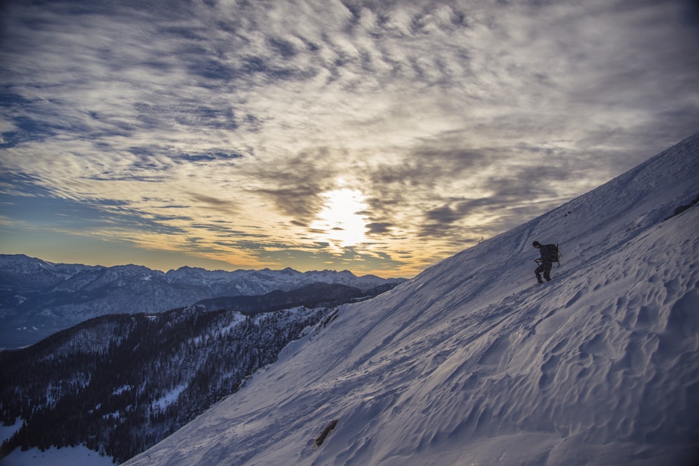 man walking on top of the mountain during daytime