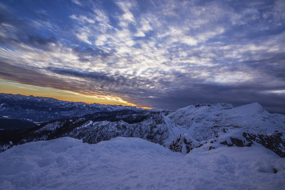 white and black mountain under blue sky at golden hour