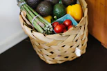 A rustic basket filled with assorted fresh vegetables ready for delivery.