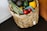 A vibrant basket filled with assorted fresh vegetables and fruits from the farm.