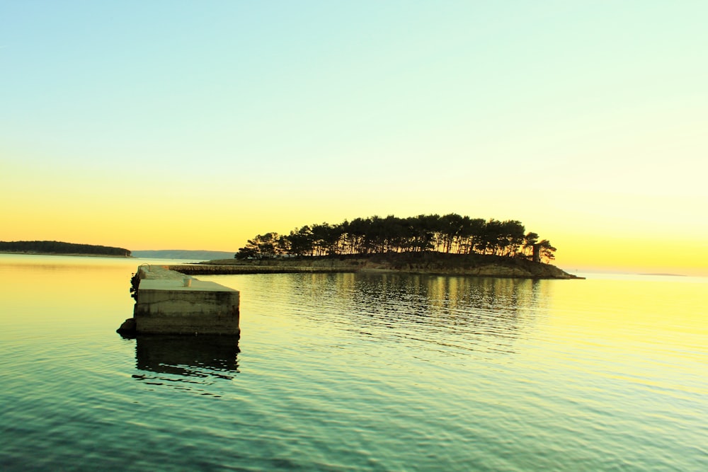 landscape photography of island in middle of body of water