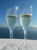 Close-up of a champagne flute catching the sunlight on a luxury yacht deck.