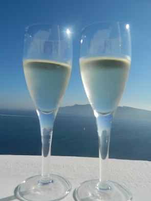 Close-up of a champagne flute catching the sunlight on a luxury yacht deck.