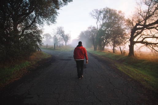 man walking on road at daytime