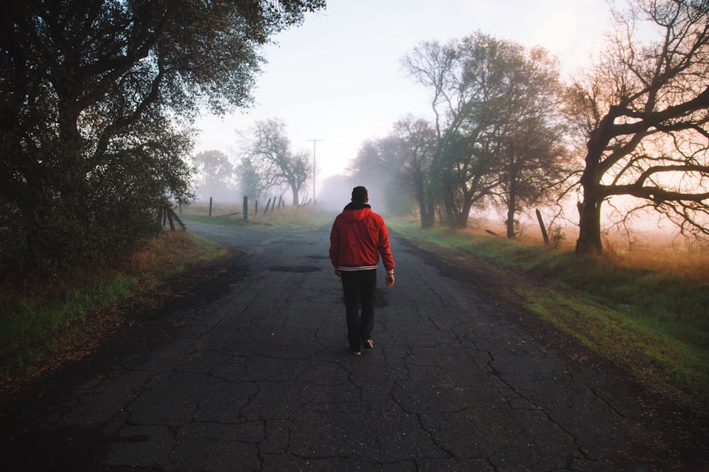 man walking on road at daytime