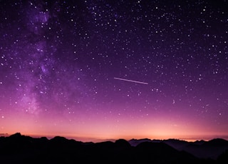 silhouette photo of mountain during night time