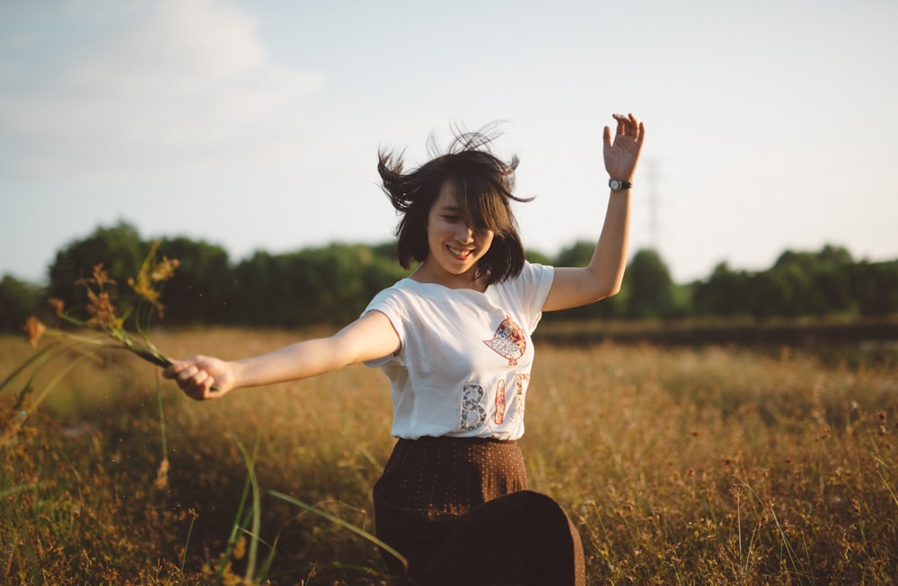 woman holding flower on field