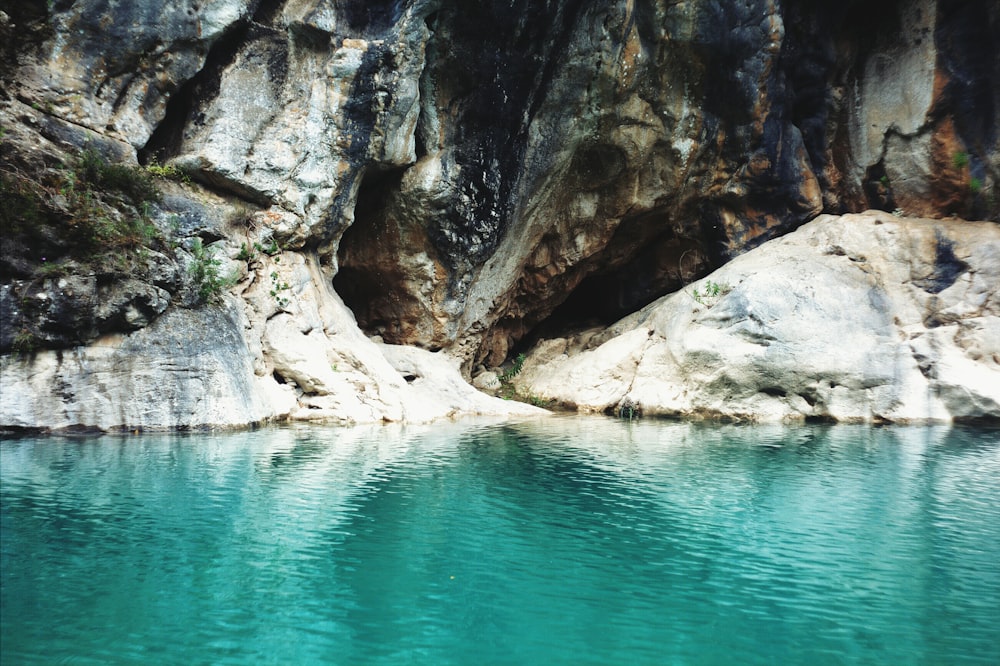 rock formation with blue water