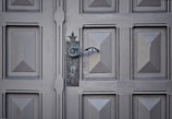 Close-up of a wooden garage door with decorative hardware.