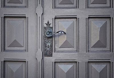 Close-up of a wooden garage door with decorative hardware.