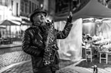 A saxophonist playing during a romantic dinner.