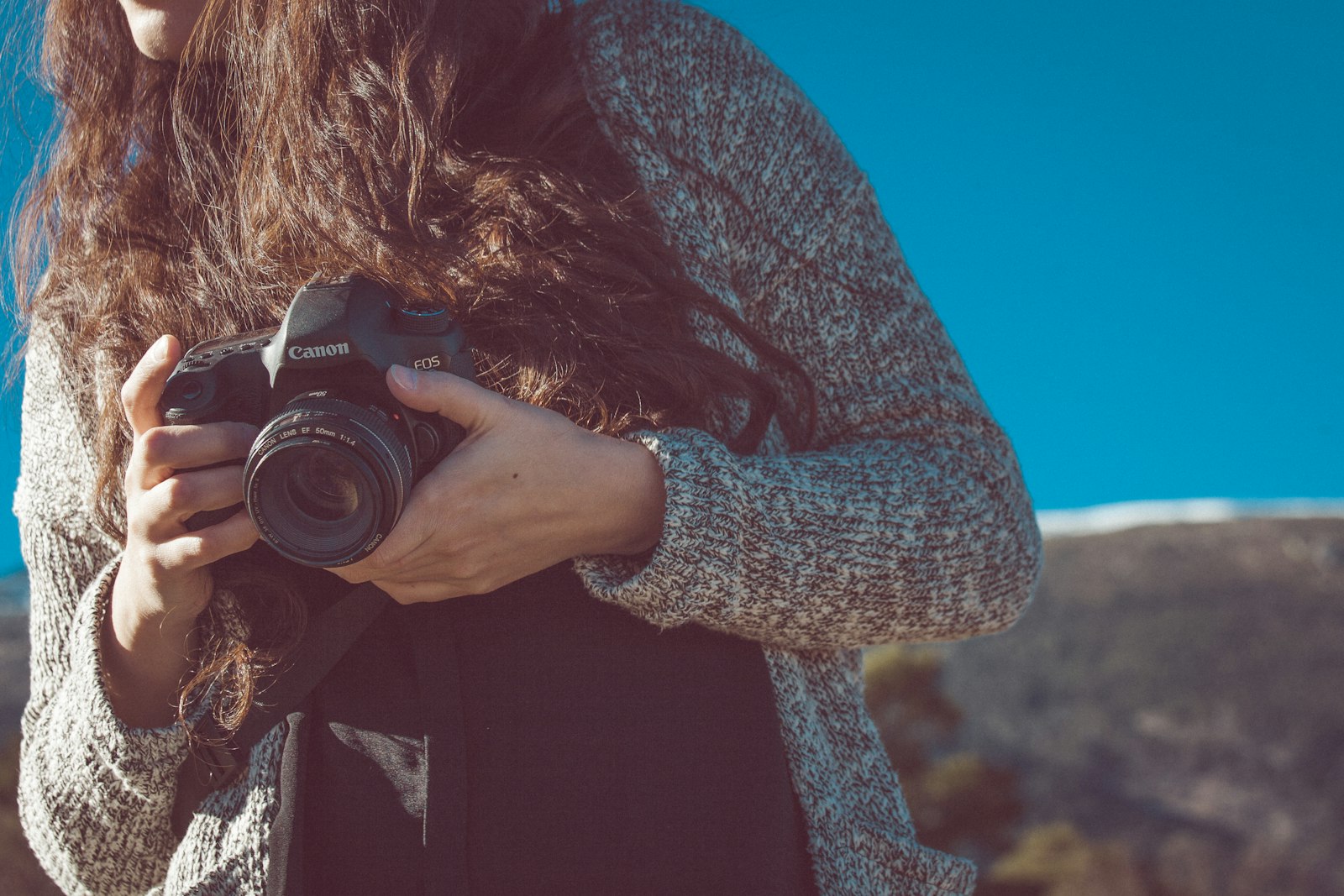 Canon EF 70-200mm F4L IS USM sample photo. Woman holding black canon photography