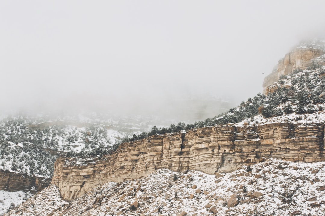 rocky mountain under gray sky at daytime