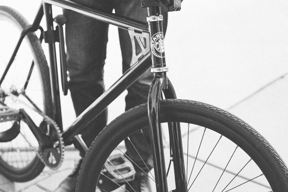 person beside black road bike