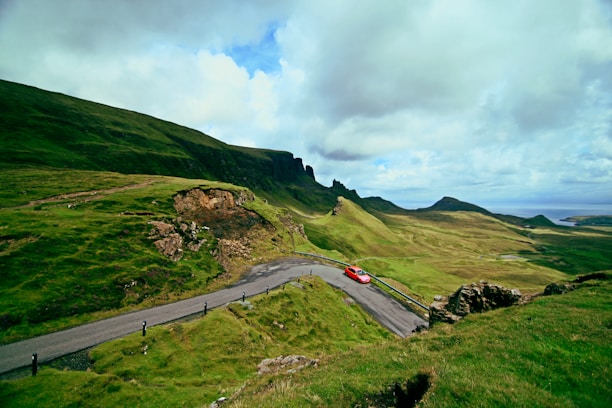 A beautiful scenery with a rented car parked in the foreground.