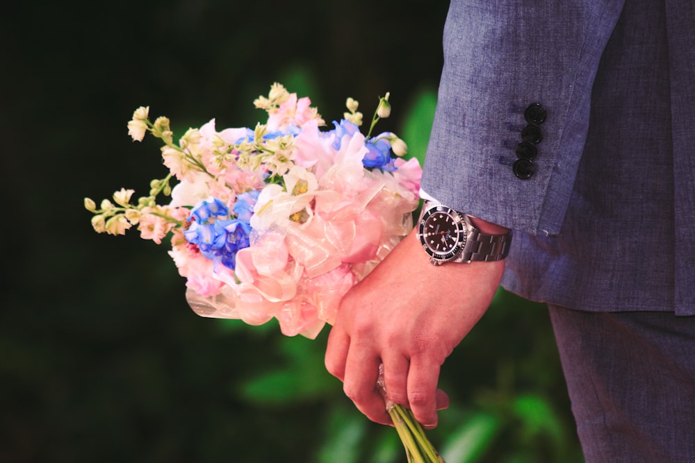 close up photography of man holding flowers