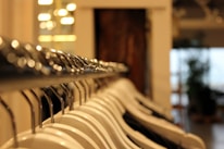 Close-up of stylish girls' clothing on hangers in a bright store.