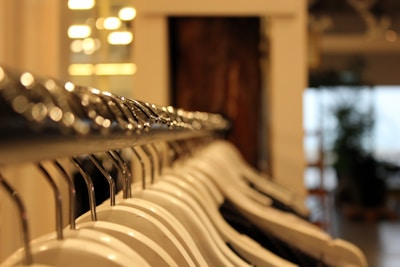Close-up of stylish girls' clothing on hangers in a bright store.