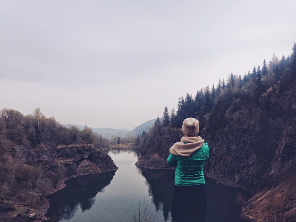 person staring at body of water