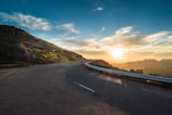 person running on road street cliff during golden hour