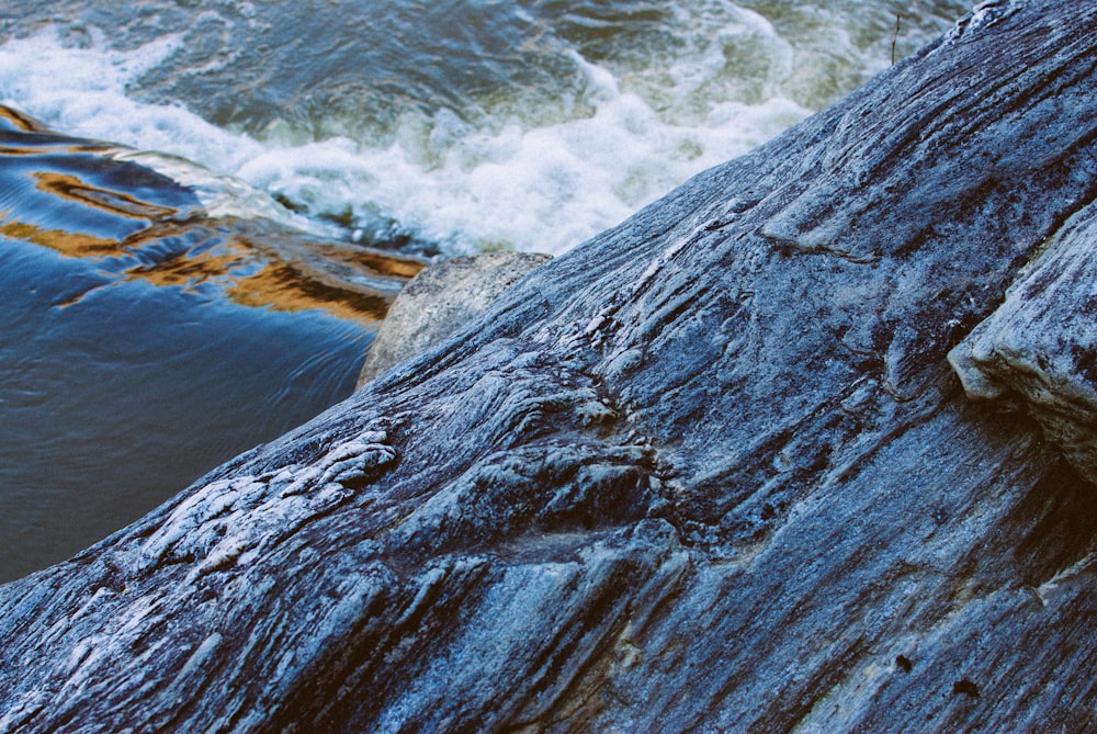 gray rock formation near body of water during daytime