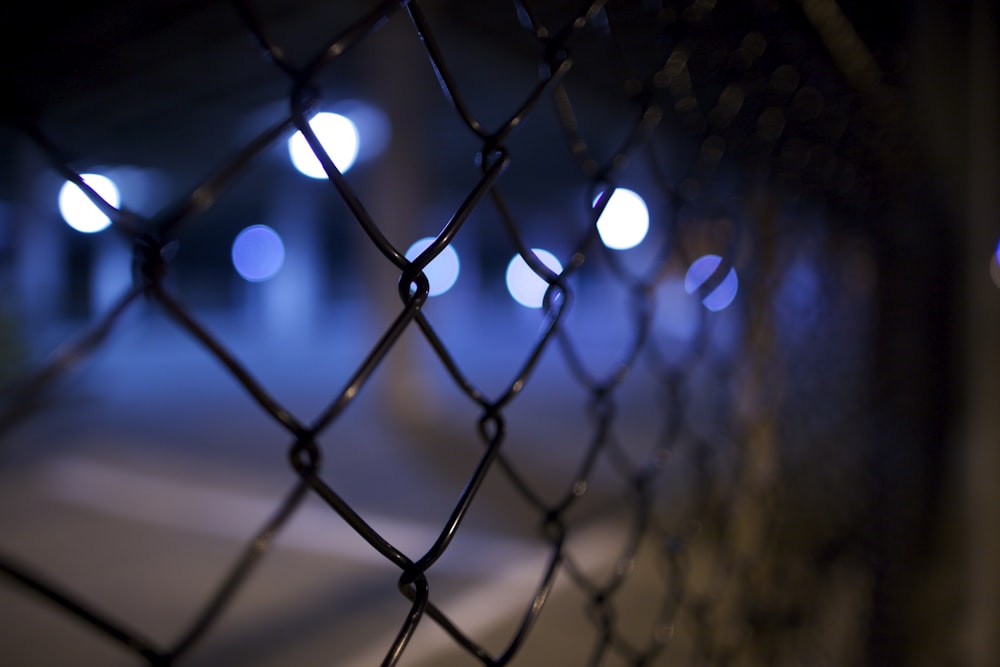 shallow focus photography of black steel gate