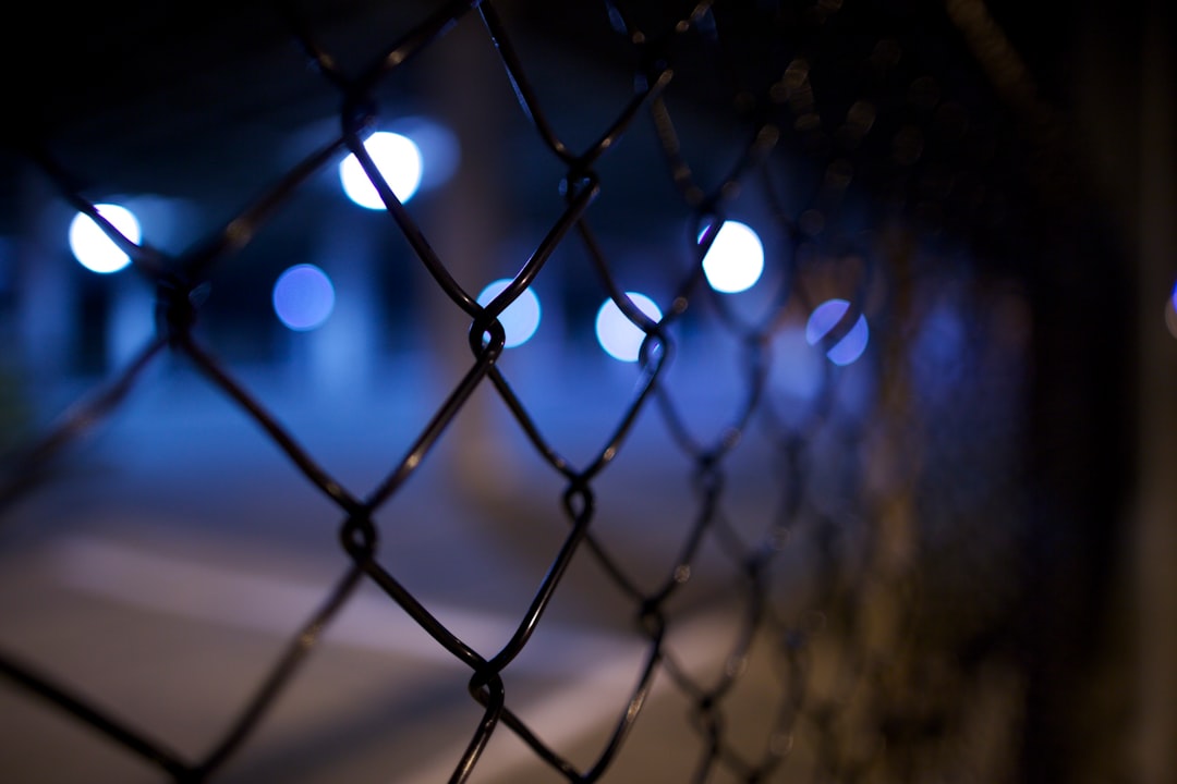 shallow focus photography of black steel gate