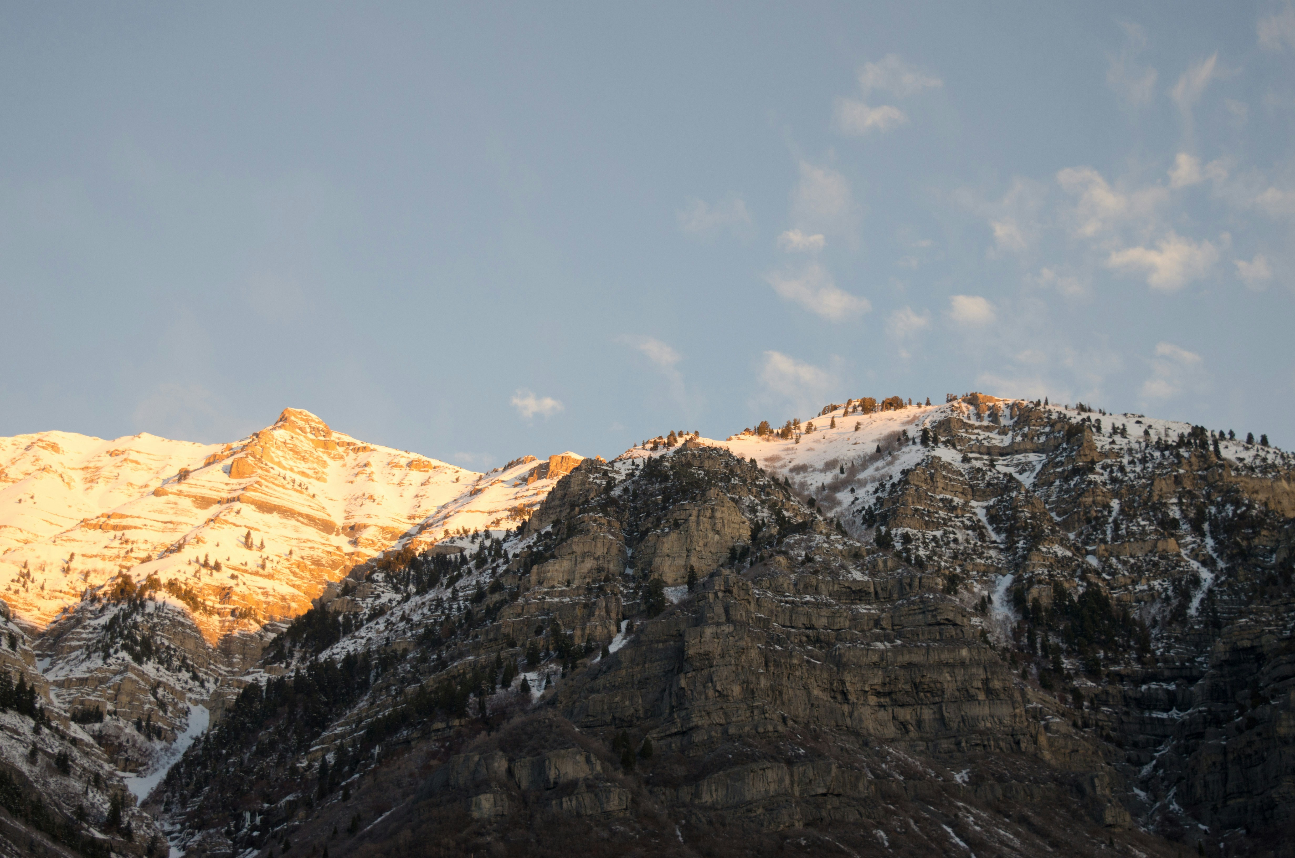 A rocky, snow-topped mountain in sunset