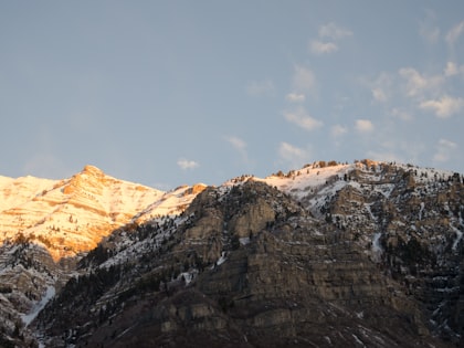 A rocky, snow-topped mountain in sunset